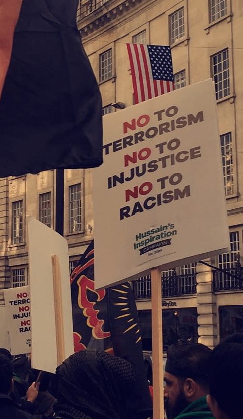 Placards against terrorism, injustice and racism being used by the mourners.