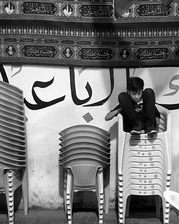 Then we grow up. And all we accumulate from the rituals is the trivialities of mourning; the black attire and the slogans. In my second or third year of university —no longer tolerating my state of incomprehension— I went to a local bookshop and asked for a book that explains the tragedy of Karbala. I remember being royally scolded by the storekeeper for trying to play catch up. After he was done roasting me on how attending Muharram lectures is by far the best way to pick up an adequate knowledge on the different aspects of Ashura, he coldly recommended one book as a starter.