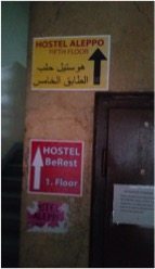 A sign for a hostel catering to Syrians.